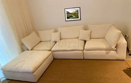 Feather-filled cushions create a soft, cloud-like seating experience.