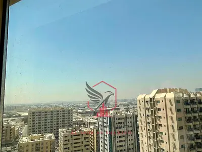 Two-bedroom apartment with living room in Al Majaz 2, free AC, open view, balcony, prime lively location close to all services and near Dubai exit.