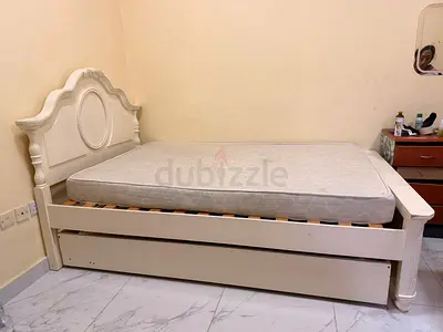 White wooden double bed with trundle and mattress