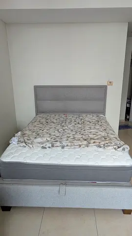 URGENT! Transport is free: Grey Fabric Bed + mattress with hydraulic lift-storage