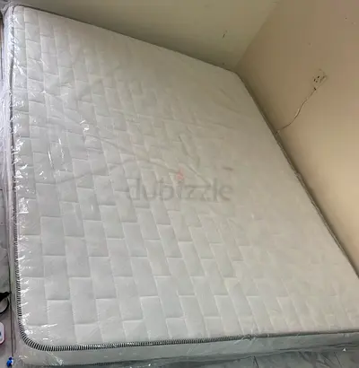 Like-new queen mattress wrapped in original plastic - firm comfort