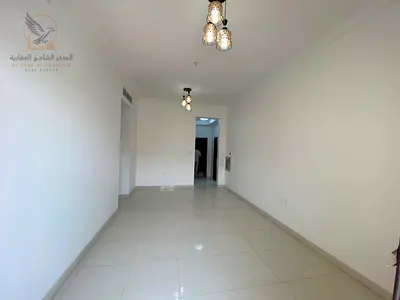 For annual rent in Al Muwaihat 3 Ajman First occupancy apartment with one bedroom living room two bathrooms balcony central air conditioning