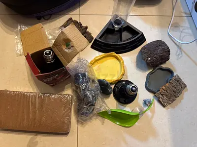 Assorted terrar decor and accessories - rocks, ornaments, and fitting. Lamps for reptiles, vitamins.