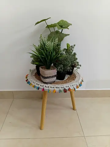 Small round plant stand with decorative tray and tassels