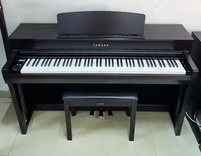 The Yamaha Clavinova CLP-745R (Dark Rosewood finish) is an 88-key digital upright piano featuring