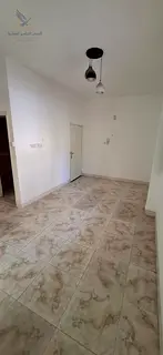 Studio apartment for annual rent in Al Rashidiya 1, Ajman. Features a separate kitchen and balcony,