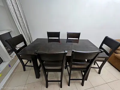 Solid dark wood 6-seater dining table with chairs - good condition