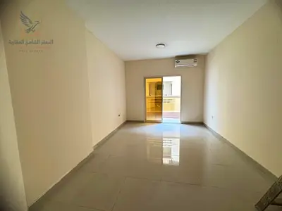 Annual rental apartment in Al Rashidiya 1 Mina Street with 2 bedrooms, living room, balcony, near Rawabi Market and easy Dubai & Sharjah access.