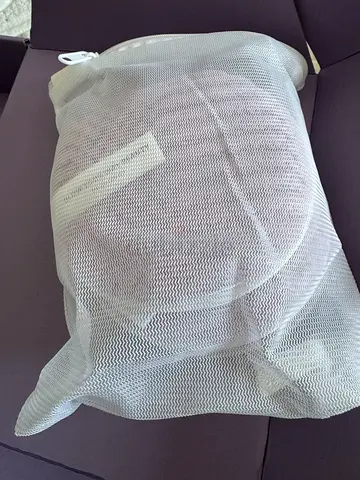 White mesh laundry wash bag with makeup remover pads inside - zipper protector for delicates
