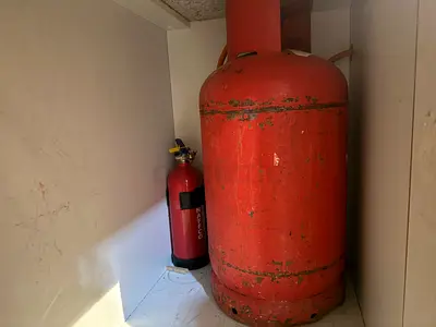 Used LPG Cylinder (medium) with regulator and pipe.