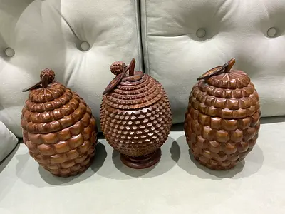 hand-carved wooden decorative container with a lid