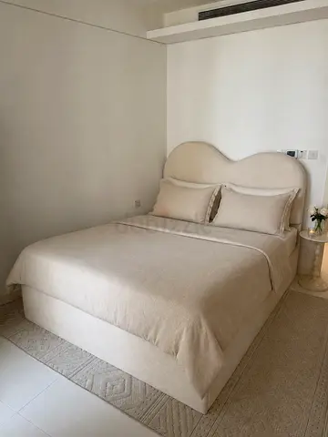 Beige upholstered double bed with headboard and mattress - good condition