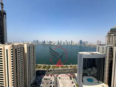 Two-bedroom apartment with a balcony and a full luxurious sea view in the finest towers of Sharjah, including all services, with modern finishing and
