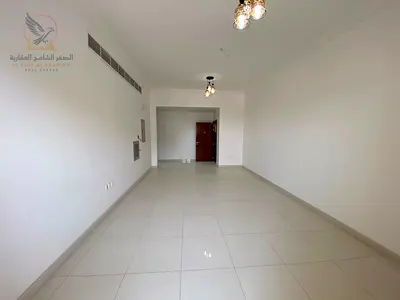 For annual rent in Al Muwaihat 3 Ajman Brand new apartment with two bedrooms a living room three bathrooms a balcony with an open view