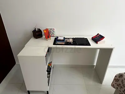 Simple white L-shaped study desk with storage