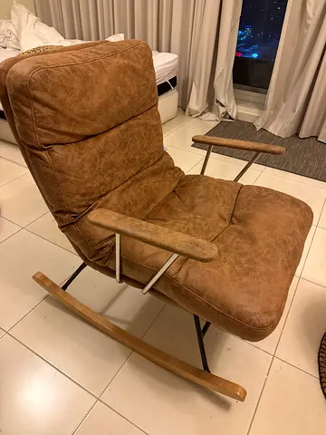 Used brown reclining lounge chair with metal frame