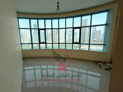 Panoramic view, free parking, spacious two-bedroom apartment with built-in wardrobes and storage, excellent finishing, for rent in Al Majaz 3
