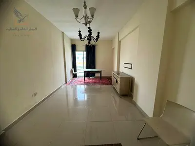 Two-bedroom apartment with a living room in Ajman, Al Rashidiya 1, behind Ramada Hotel, with two balconies, available for annual rent at a very specia