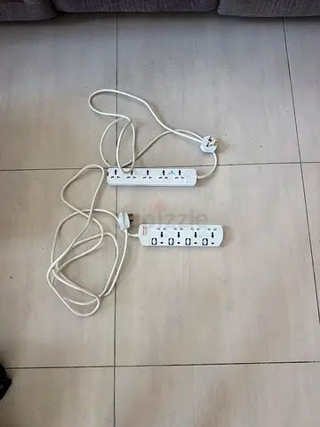 Two white power extension strips with surge protection