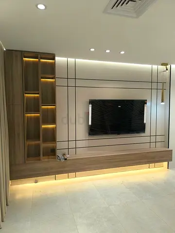 Modern wall-mounted entertainment unit with built-in LED shelving