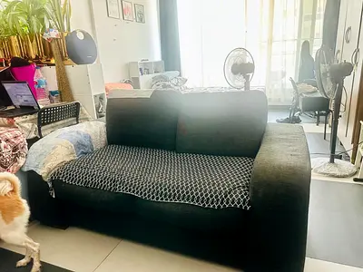 Comfortable 2-Seater Dark Grey Sofa in Good Condition.