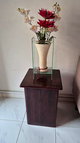 Wooden pedestal table with vase