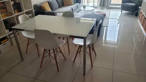 Modern glass-top dining table with 4 chairs - good condition
