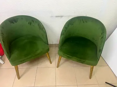 Pair of green velvet tub chairs with wooden legs