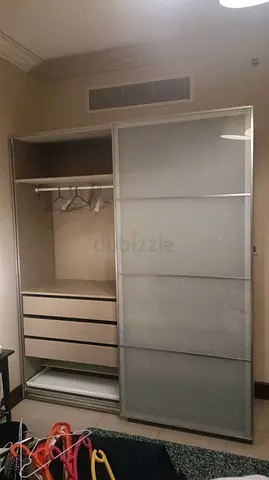 Used sliding-door wardrobe with drawers and hanging rail - good condition