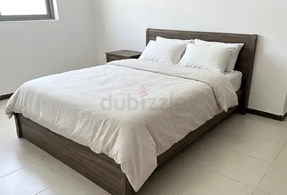 Dark wood queen bed frame with mattress and bedside table - good condition