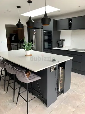 Modern matte black kitchen island with quartz countertop and wine cooler