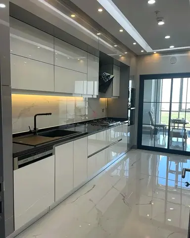 Modern white gloss fitted kitchen cabinets with integrated appliances | custom made in Dubai