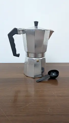 Used stovetop Moka espresso coffee maker (6-cup) with scoop