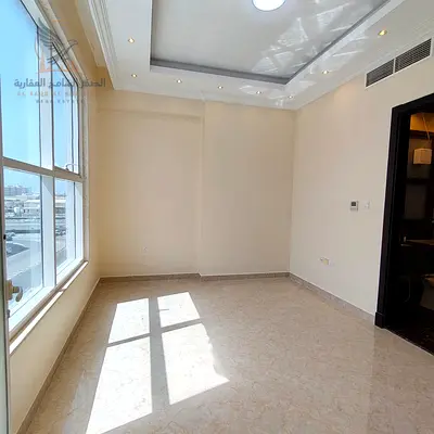 For annual rent in Ajman a two-bedroom apartment in Al Rawda 3 featuring two bathrooms a balcony with a view modern finishes excellent space private