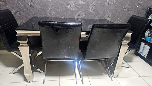 6 seater Black dining table with glass top and steel bottom
