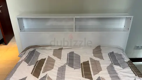 White wooden headboard with built-in shelf - good condition
