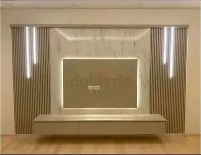 Modern wall-mounted TV entertainment unit with LED lighting and storage