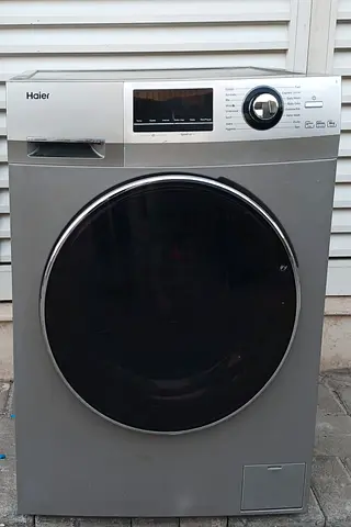 This front load Haier 8k washing machine, color grey, condition is working perfectly.