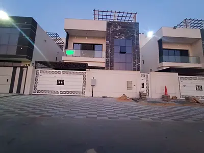 For rent in Al Helio 2, Ajman: A 7-bedroom villa featuring a majlis, a living area, a spacious kitchen, and a maid's room. First-time occupancy.