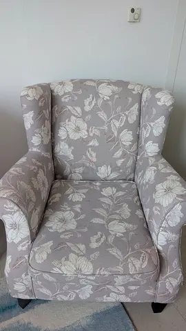 Comfortable floral upholstered armchair — good condition