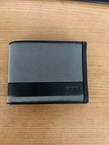TUMI men's bi-fold wallet — black & gray canvas leather