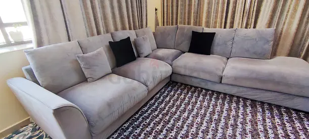 Light grey L-shaped sectional sofa, comfortable and well-kept