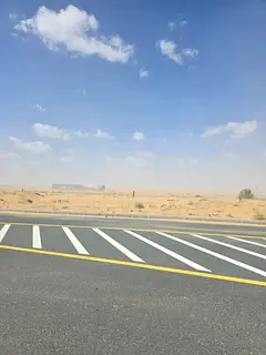 Commercial land for sale in Rawdat Al Qurt area, on the main road in Al Ruwaidat suburb, Sharjah.