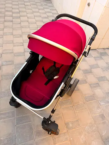 Lightweight red baby stroller in good condition