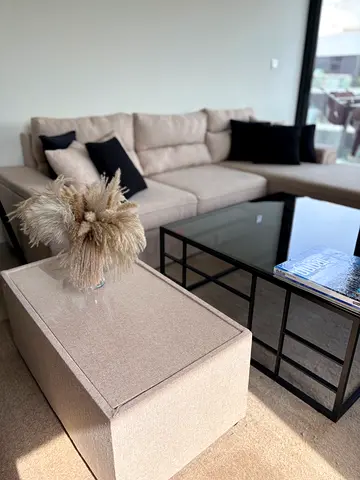 Beige L-shaped Sofa with Glass Coffee Table and Ottoman - Good Condition