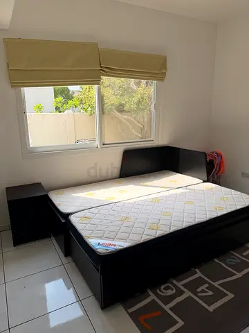 Queen size black sofabed frame with mattress and two bedside tables - good condition