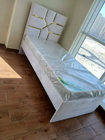 Single white velvet bed with gold-accented headboard, like-new