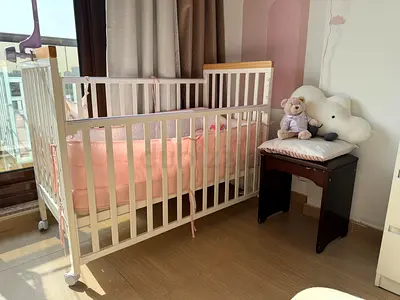 White wooden baby crib with mattress and bumper - good condition
