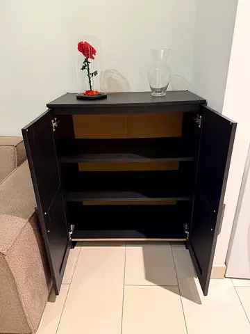 Small black storage cabinet with shelves and double doors
