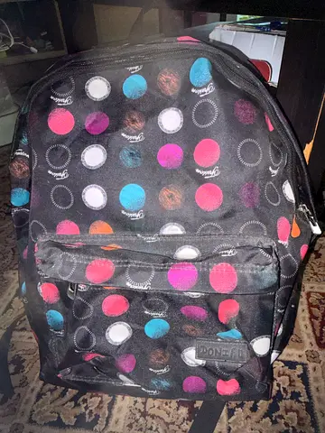 Black polka dot backpack with front pocket — good condition